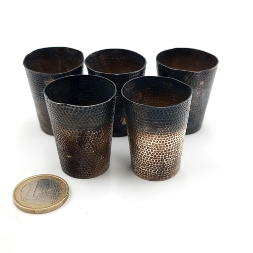 401 - A collection of five traditional Chinese hammered silver liquor cups. With silver and reign marks to... 