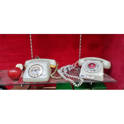 452 - Two vintage rotary dial telephones, including a West German made example, along with a slate grey Er... 