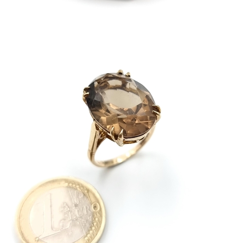 652 - A fabulous unisex 12 carat  Smokey Quartz impressive  ring. This ring is set in 9 carat gold and is ... 