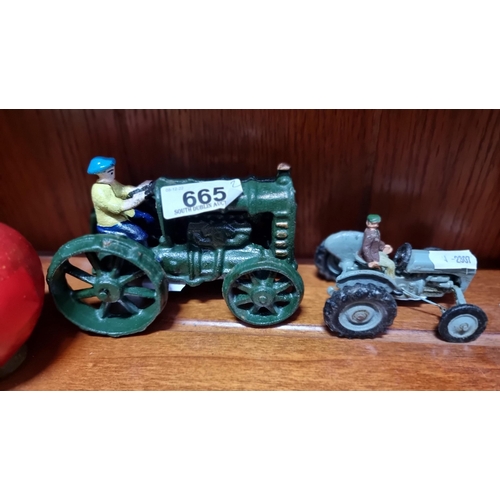 665 - Two, cast metal tractor models. With fully rotational wheels and hand painted finish. Very charming.