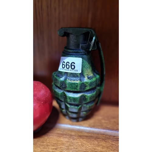 666 - A cast metal grenade replica. In a hand-painted finish.