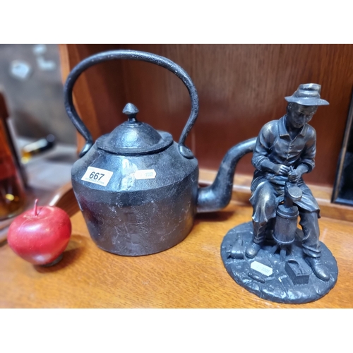 667 - A large cast metal heavy  teakettle with a traditional cobbler figure .