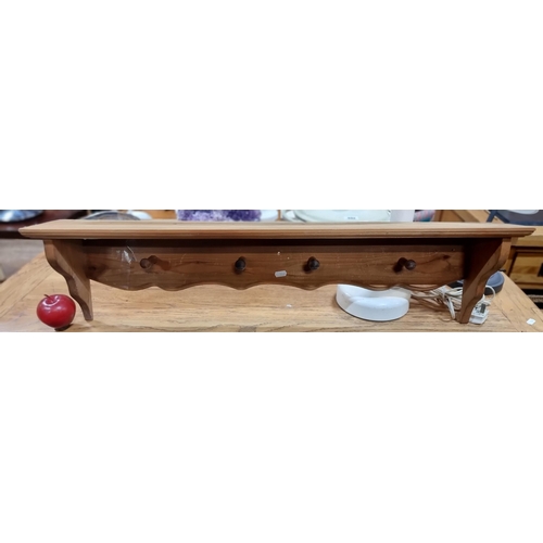 687 - A wall hanging pine coat rack with shelf to top and four hooks.