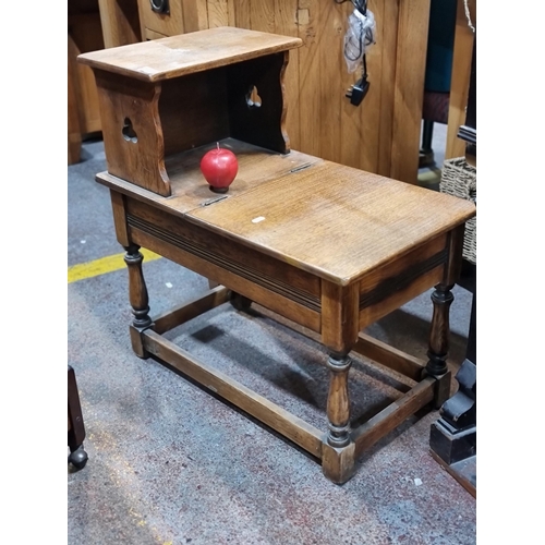 696 - A nice example of a vintage oak stool with two tiers, one lifting to reveal storage shelf below. Nic... 