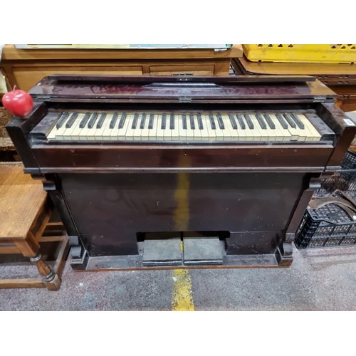 699 - A fantastic neat size piano with cast metal handles to side and pneumonic pump pedals below.