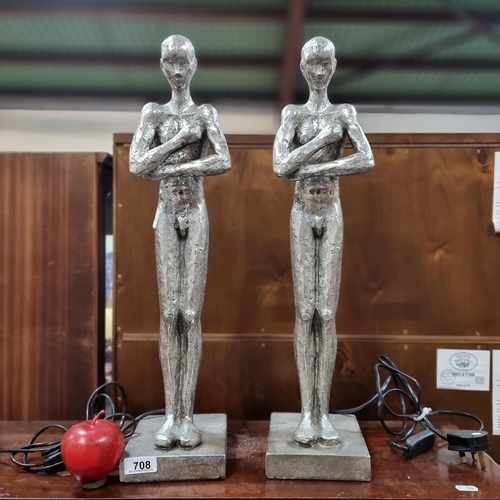 708 - A pair of silver toned figurative lamps with single bulb to back.