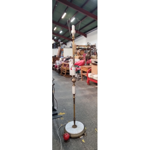 740 - A tall floor standing lamp with footed base and decorative marble and brass stem.