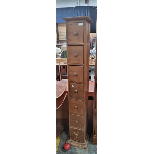 751 - A tall slim wooden filing unit with six square drawers and knob handles.