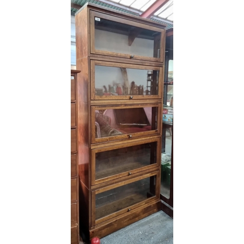 752 - Star lot : A legal style five shelf display cabinet with glass paneled pocket doors that lift up and... 