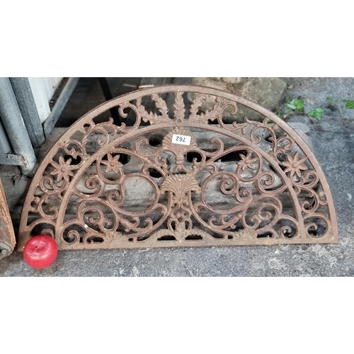 762 - A pretty example of a 19th century  cast metal grate. Half-moon grate featuring ornate scroll detail... 