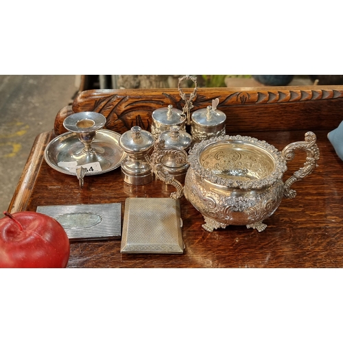 764 - A selection of seven vintage EPNS items including an elegant chamber candleholder, a pair of salt an... 