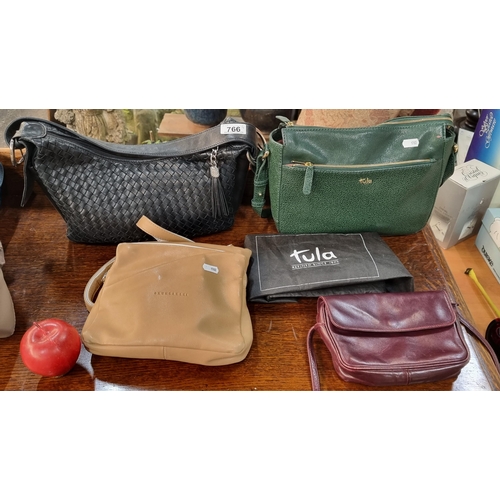 Four leather ladies' handbags including a striking emerald green