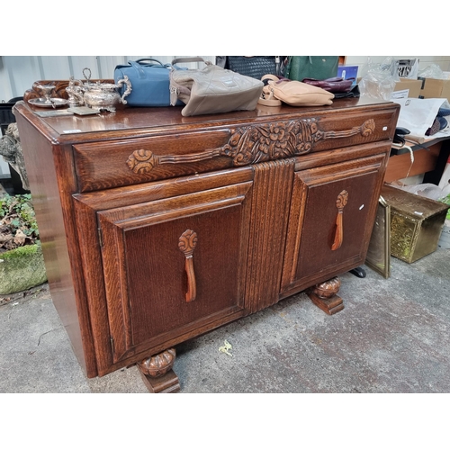 767 - A fantastic, Art Deco 1930s polished oak sideboard. A very beautiful example with curved edges, carv... 