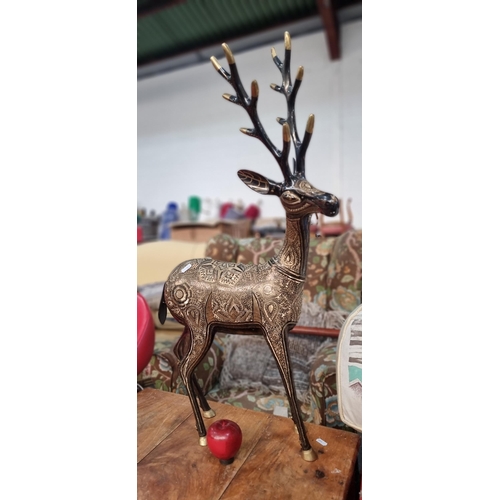 798 - A beautiful sculpture of a metal stag, profusely etched with stunning folk art motifs, hand painted ... 