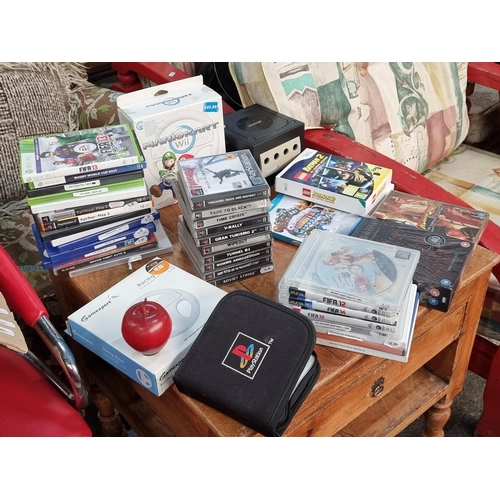 803 - A large box of mixed media and console games. Including Playstation, Wii, Playstation Pal and a Nint... 