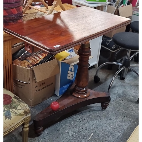 816 - An elegant, Victorian, mahogany sewing machine table. Supported by a turned baluster base. Featuring... 