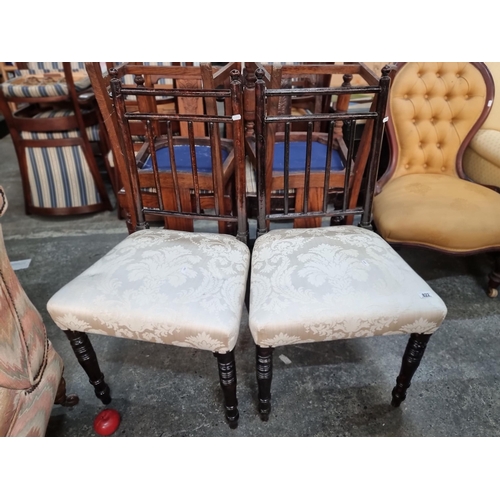 822 - A pair of turned Edwardian dining chairs. Upholstered in a very lovely cream damask fabric. Featurin... 