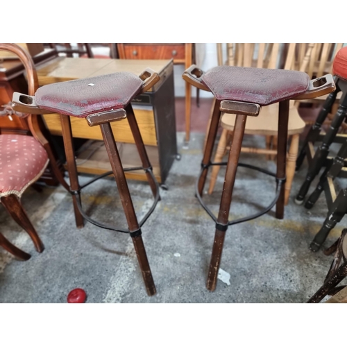 840 - Two fabulous vintage bar stools with unusual handles to side and back of seat and cast metal stretch... 