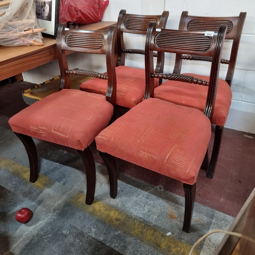 843 - Four antique chairs with carved twist ornament to back and reeded edges and saber legs, all upholste... 