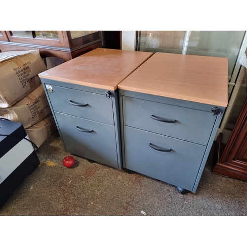 907 - Two very practical office filing lockers, on castor wheels with two drawers each. Both keys included... 