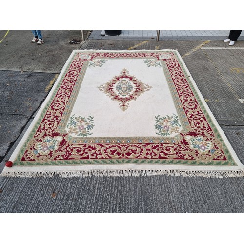 783 - Star lot : A beautiful large floor rug in shades of cream, red and blue with traditional centre meda... 