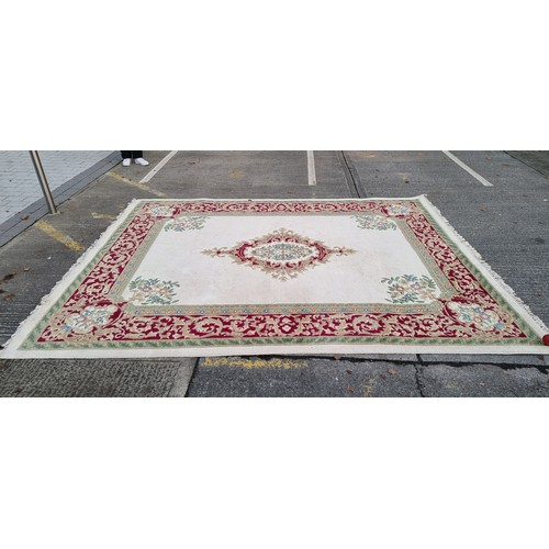 783 - Star lot : A beautiful large floor rug in shades of cream, red and blue with traditional centre meda... 