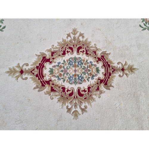 783 - Star lot : A beautiful large floor rug in shades of cream, red and blue with traditional centre meda... 