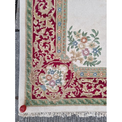 783 - Star lot : A beautiful large floor rug in shades of cream, red and blue with traditional centre meda... 