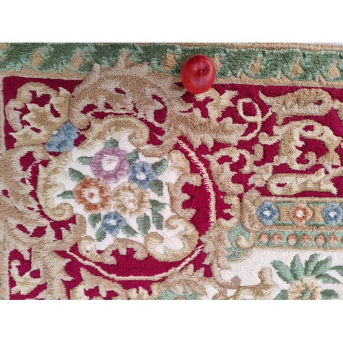 783 - Star lot : A beautiful large floor rug in shades of cream, red and blue with traditional centre meda... 