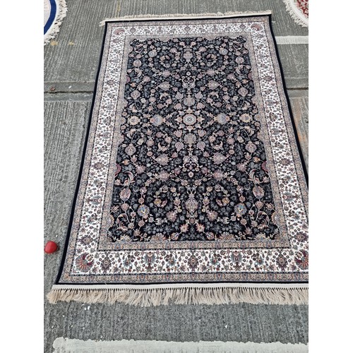 817 - Star lot : A lovely Kashmiri floor rug in shades of black, pink, purple and cream. L260cm x W160cm V... 