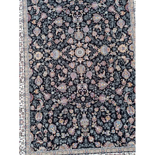 817 - Star lot : A lovely Kashmiri floor rug in shades of black, pink, purple and cream. L260cm x W160cm V... 