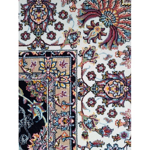 817 - Star lot : A lovely Kashmiri floor rug in shades of black, pink, purple and cream. L260cm x W160cm V... 