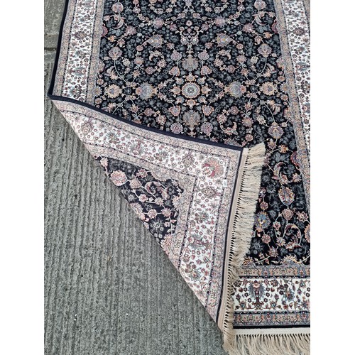 817 - Star lot : A lovely Kashmiri floor rug in shades of black, pink, purple and cream. L260cm x W160cm V... 