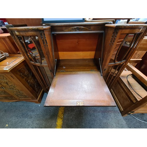 680 - Star lot : A fantastic Art Deco writing table with two astroglazed display cabinets to each side wit... 