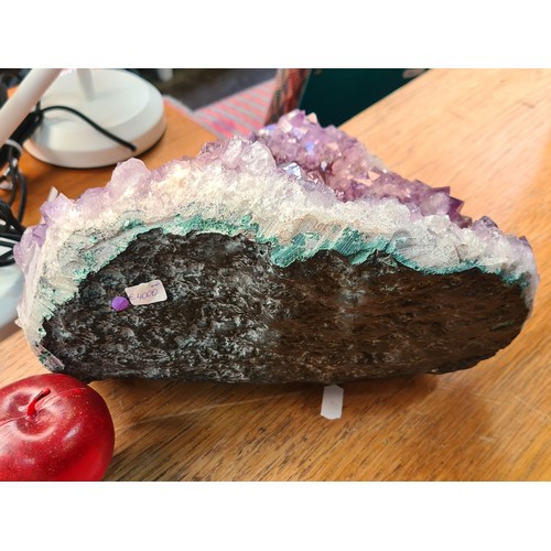 691 - Star lot : A very large, very heavy geode of amethyst crystal with a rare white natural Crystal inte... 