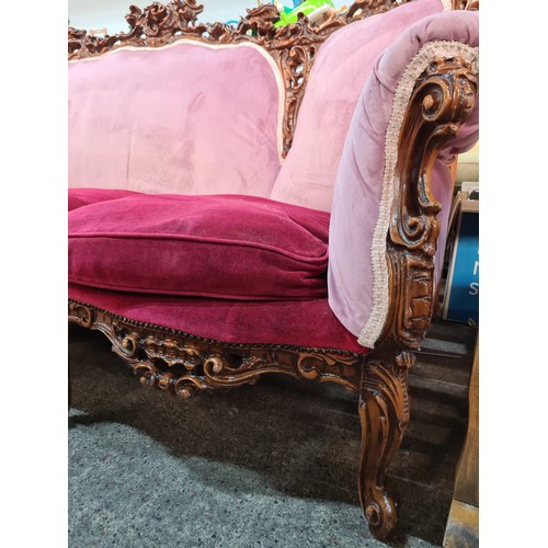 793 - Star lot : A very striking three-seater sofa with a lavishly carved frame in high relief with a glos... 