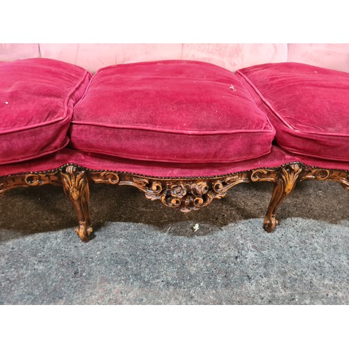 793 - Star lot : A very striking three-seater sofa with a lavishly carved frame in high relief with a glos... 