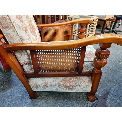 802 - A pair of vintage, solid wood deep-seat armchairs. With rattan detailing under the armrests. Upholst... 