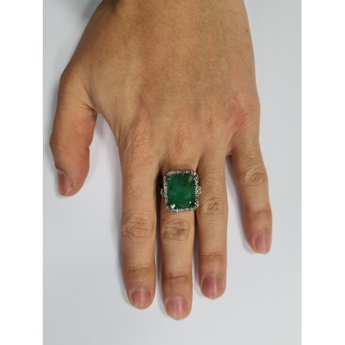 56 - Star lot : A huge and impressive 10.5 carat Emerald ring, set beautifully with .60 of Diamonds and m... 