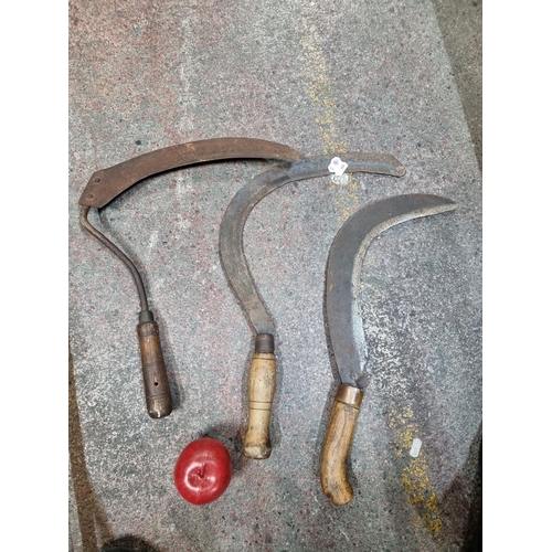 700 - Three antique Irish sickles with wooden handles.