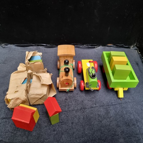 744 - A mixed lot of vintage wooden toys including a colourful wooden train with string pully, along with ... 