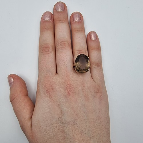 652 - A fabulous unisex 12 carat  Smokey Quartz impressive  ring. This ring is set in 9 carat gold and is ... 