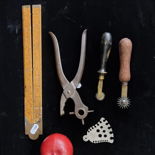 108 - A selection of five, vintage leather-working items. Including two perforating tracer wheels, includi... 