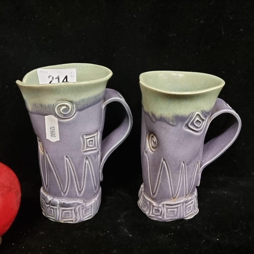 214 - A pair of very unusual large abstract art pottery mugs with geometric designs. In an asymmetrical fo... 