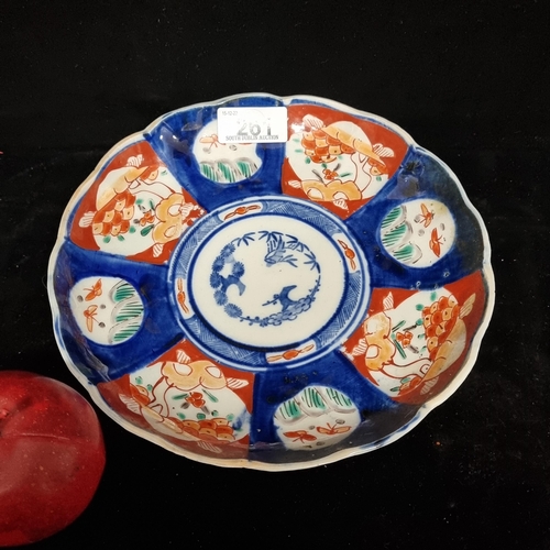 261 - A beautiful antique Large Japanese Imari porcelain plate. This lovely piece boasts a scalloped board... 