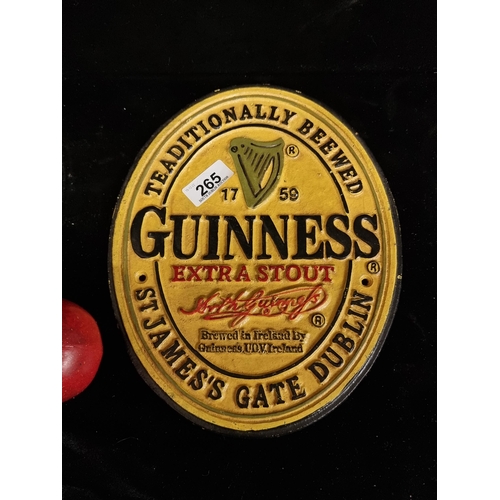 265 - A wall plaque in cast metal, advertising Guinness stout. Hand-painted in yellow with red and black t... 