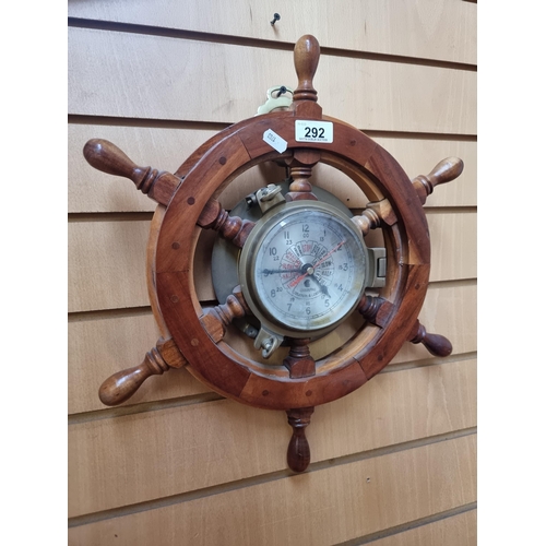 292 - A vintage wooden ships helm with brass porthole clock to centre featuring a ships telegraph made by ... 