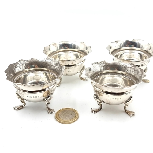 50 - A very fine set of four sterling silver antique footed table cruets, featuring beautiful scalloped r... 
