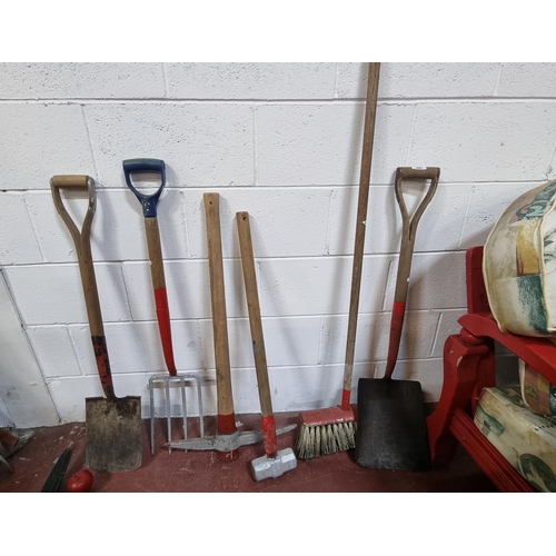 597 - A selection of six vintage long handled garden tools including spades, snow shovel, pickaxe and pitc... 