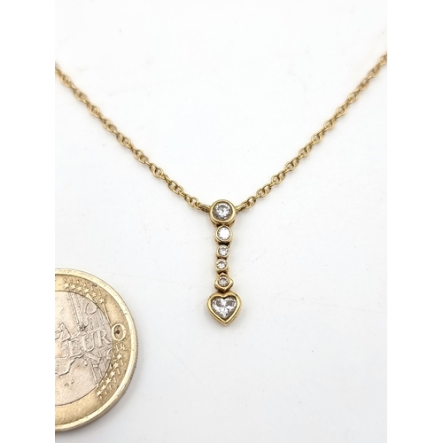 605 - A beautiful 18 carat sweet-heart Gold chain, set with 6 Diamonds in a drop pendant which features a ... 